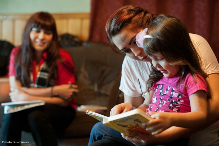 Mom Jalyssa reading to her daughter