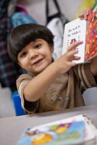 Three-year-old Victor enjoys a book during daycare