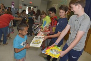 Students giving books away from Carlthorp School